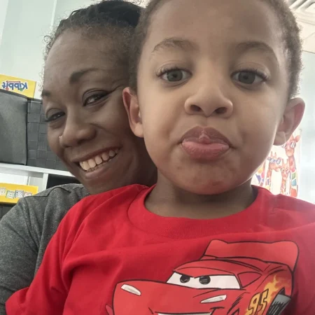 Two children smiling together during a therapy visit