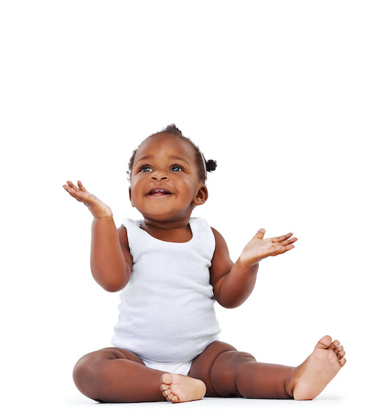 Infant sitting upright and reaching