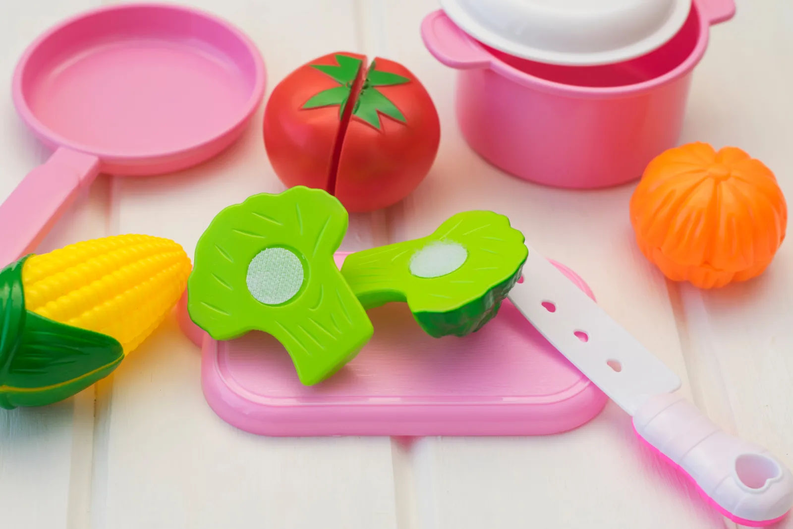 Colorful toy food, cookware, and utensils for pretend play