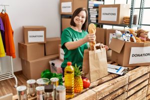 Young adult volunteering in a donation-sorting setting