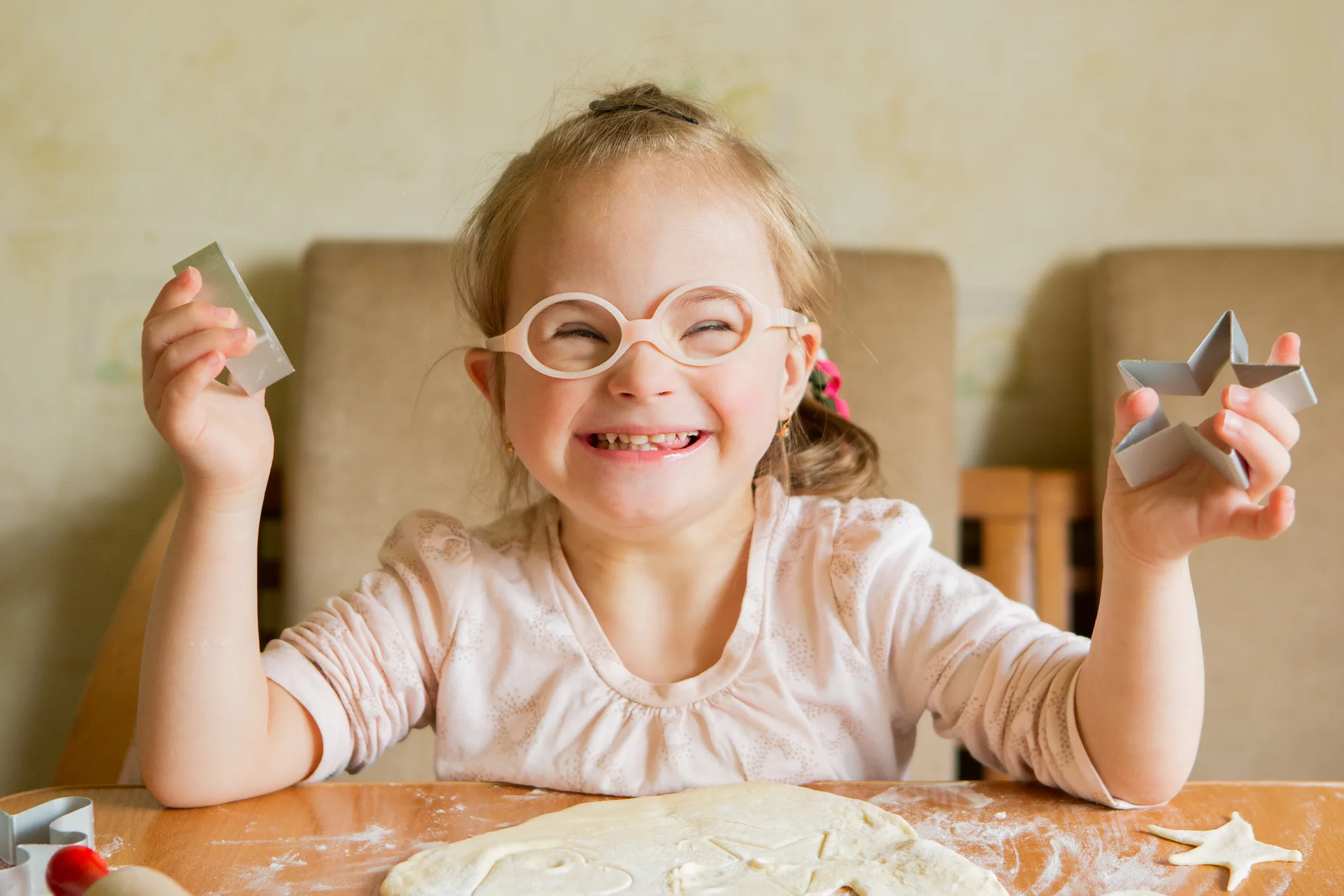 Little girl with glasses and a cookie cutter